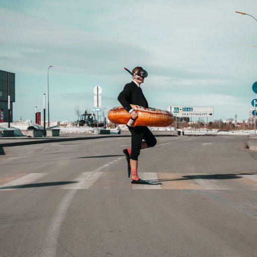 strange man with swimming equipment on street