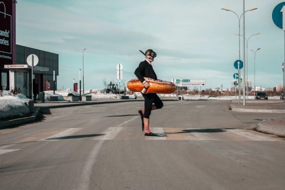 strange man with swimming equipment on street