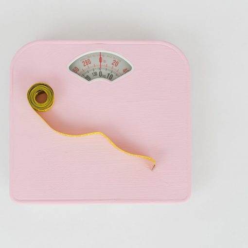 scales and measuring tape on white floor