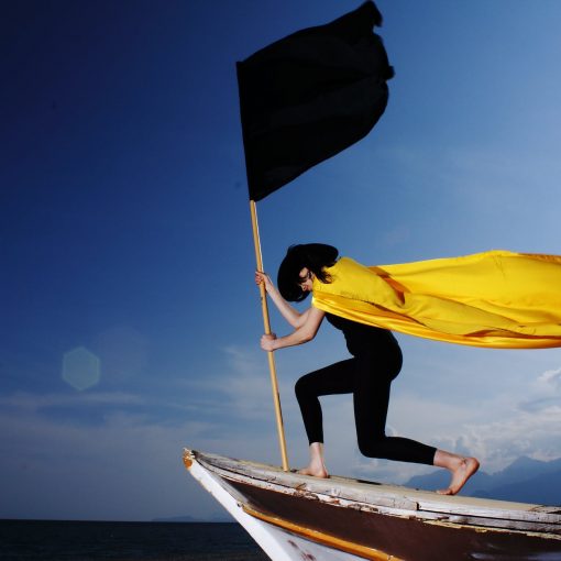 woman holding black flag