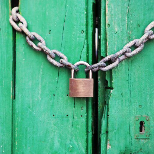 brass colored metal padlock with chain