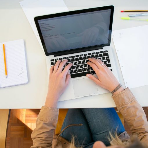 woman working on laptop with documents