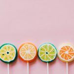 assorted colorful lollipops on pink background
