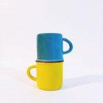 colorful stacked blue and yellow mugs