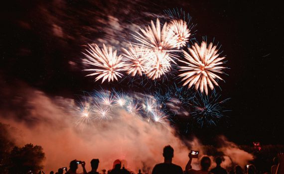 people watching fireworks display during nighttime