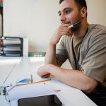 man sitting at desk in office thinking