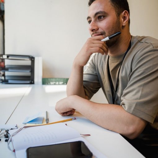 man sitting at desk in office thinking