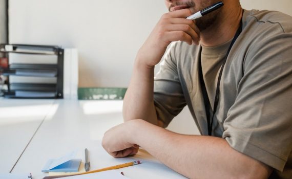 man sitting at desk in office thinking