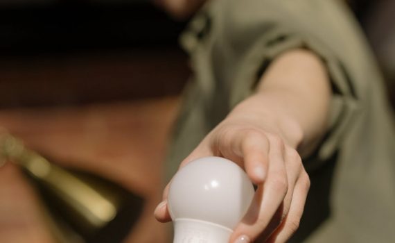 person holding white light bulb
