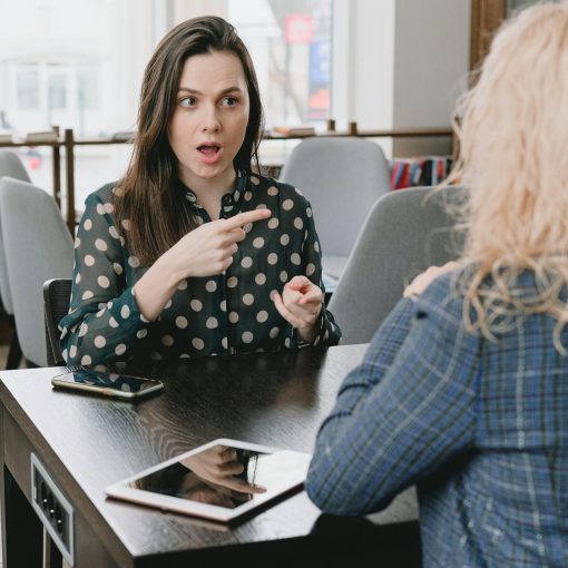 shocked woman poinitng a finger on her acquaintance