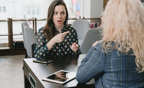 shocked woman poinitng a finger on her acquaintance